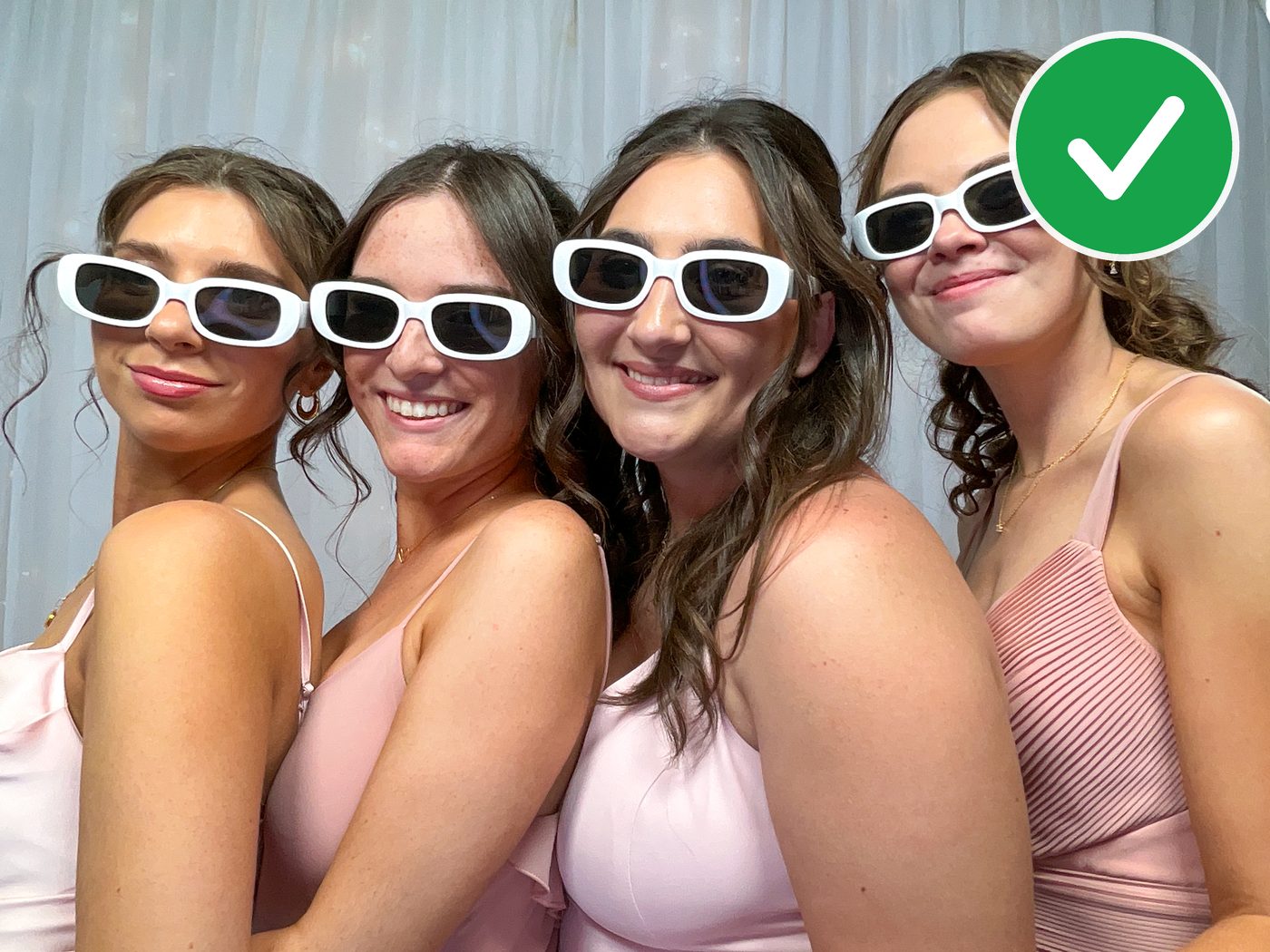 Four guests in dark sunglasses, evenly lit with no glare, shot with two side lights